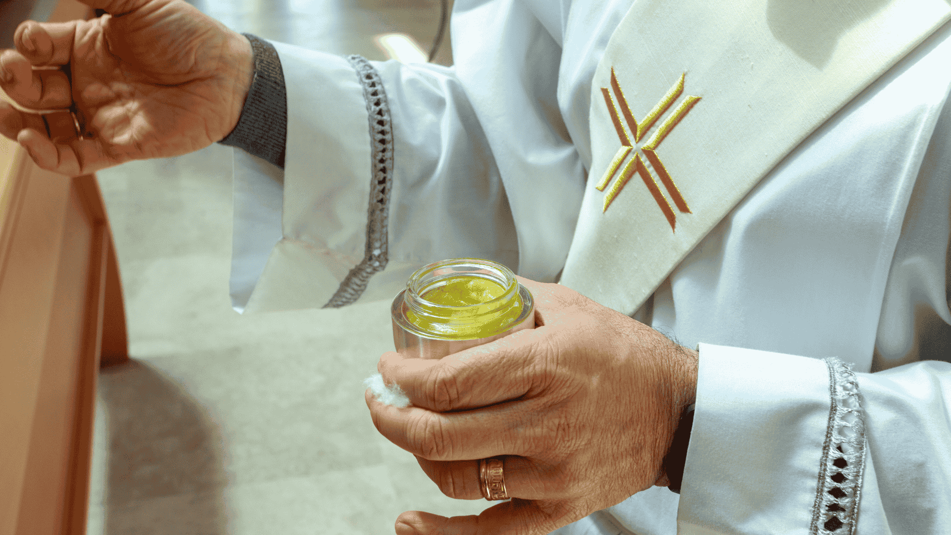 catholic priest with anointing holy anointing oil for confirmation